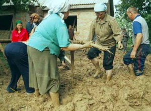 Toloka in Sadove village, 2004. Neighbors help to build a house